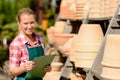 Garden center woman standing by clay pots Royalty Free Stock Photo