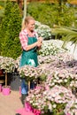 Garden center woman write notes potted flowers Royalty Free Stock Photo