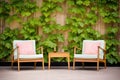 garden chairs in front of ivycovered wall Royalty Free Stock Photo