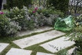 The garden decoration with artificial stone made of green transparent glass among flowers