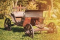 Garden Decoration Concept. Decorative Yard Wagon On Summer Lawn. Bright Sunny Day. Gardening And Housekeeping. Vintage Royalty Free Stock Photo
