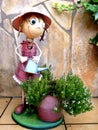 Garden decoration of a funny statue watering the plants