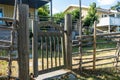 Garden design. Authentic old wooden fence with gate entrance to the garden. Garden design with aged shabby fence hedge. Royalty Free Stock Photo