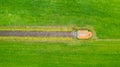 garden detail in aerial view with sand path going between two hedges towards a little building, a shed or chapel, in the Royalty Free Stock Photo