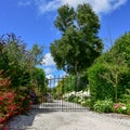 Garden Entrance with variety of blooming flowers and iron gate Royalty Free Stock Photo