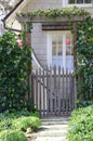 Garden entry gate with climbing ivy provides a graceful entrance to a quaint home, Carmel-by-the-Sea, CA.