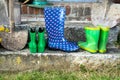 Garden equipment - rubber boots, schovels and srtaw hats in sunny day Royalty Free Stock Photo