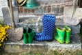 Garden equipment - rubber boots, schovels and srtaw hats in sunny day Royalty Free Stock Photo