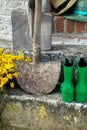 Garden equipment - rubber boots, schovels and srtaw hats in sunny day Royalty Free Stock Photo