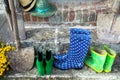 Garden equipment - rubber boots, schovels and srtaw hats in sunny day Royalty Free Stock Photo