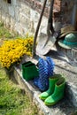 Garden equipment - rubber boots, schovels and srtaw hats in sunny day Royalty Free Stock Photo