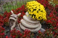 Garden figure of a snail with yellow flowers. Garden design. Royalty Free Stock Photo