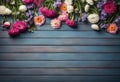 Garden flowers over blue wooden table background. Backdrop with copy space Royalty Free Stock Photo