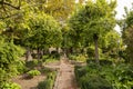 Garden with fruit and palm trees, cobblestone walking paths. Gardens at the Alcazar de los Reyes Cristianos in Cordoba