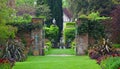 Garden Gate with Plants and Statue. Royalty Free Stock Photo