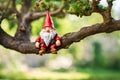 Garden gnome on a tree branch.