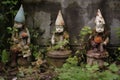 garden gnomes chipped paint revealing aged material