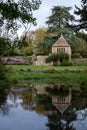 Garden at Great Chalfield Manor near Bradford on Avon, Wiltshire, UK, photographed from across the moat in autumn. Royalty Free Stock Photo