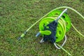 Garden green water hose roll on grass field Royalty Free Stock Photo