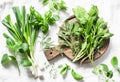 Garden herbs - spinach, basil, thyme, rosemary, sage, mint, onion, garlic on a light background, top view. Fresh food ingredients