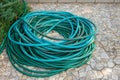 The garden hose is folded on the ground Royalty Free Stock Photo