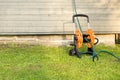 Garden hose on the house wall background. gardening and watering concept Royalty Free Stock Photo