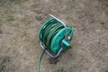 Garden hose reel on dry grass Royalty Free Stock Photo