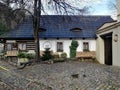 garden with house and blue roof and small trees