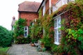 Garden and house in UK style. Front of English House. Scenic View of Colorful Flowerbeds and an Attractive English