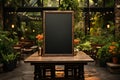 Garden inspired dining A blank menu blackboard, complemented by lush potted greenery