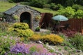 Garden in Ireland in summertime featuring rockery, forge building and patio with seating area Royalty Free Stock Photo