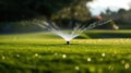 Garden irrigation system lawn. Automatic lawn sprinkler watering green grass. Selective focus. Royalty Free Stock Photo