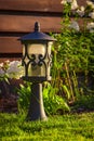 Garden lamp, made in the Middle Ages, on a lawn with a juicy green grass Royalty Free Stock Photo