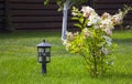 Garden lamp, made in the Middle Ages, on a lawn with a juicy green grass Royalty Free Stock Photo