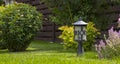 Garden lamp, made in the Middle Ages, on a lawn with a juicy green grass Royalty Free Stock Photo