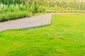 Garden landscape design with pathway intersecting bright green lawns and shrubs white sheet walkway in the garden