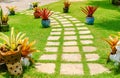 Garden landscape design with pathway intersecting green lawns and Potted flowers. sheet walkway in the garden. Landscape design wi