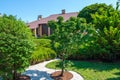 Garden with nicely trimmed bushes and trees in front of European style villa. Royalty Free Stock Photo