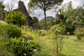 Garden of Ninfa in Italy with flowers, trees and ruins of the medieval city Ninfa.