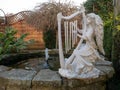 Garden ornament on side of pond water feature Royalty Free Stock Photo