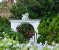 Garden ornament with white rabbit on arch