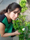 young woman with dress showing a gardenia flower