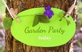 Garden party today, shield with text on a tree trunk