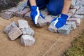 Garden path construction - worker laying granite stone pavers Royalty Free Stock Photo