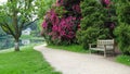 Garden Path with a Lawn, Trees, Flowers and a Lake Beyond Royalty Free Stock Photo