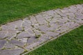 Garden path made of natural stone paved with different size rough rock. Royalty Free Stock Photo