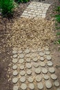 Garden path made of natural wooden planks, stones, gravel. Healthy sensory path with different surfaces Royalty Free Stock Photo