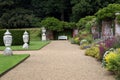 Garden path with ornaments, bench, and herbaceous border