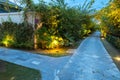 Garden path in resort with warm light and trees on side at evening, Garden Decoration Royalty Free Stock Photo