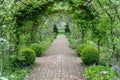 Garden Path Trellis Tunnel with Leafy Plants And Flowers